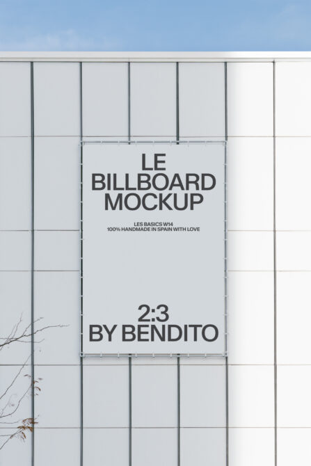 White 2:3 billboard mounted on industrial metal grid wall outdoor