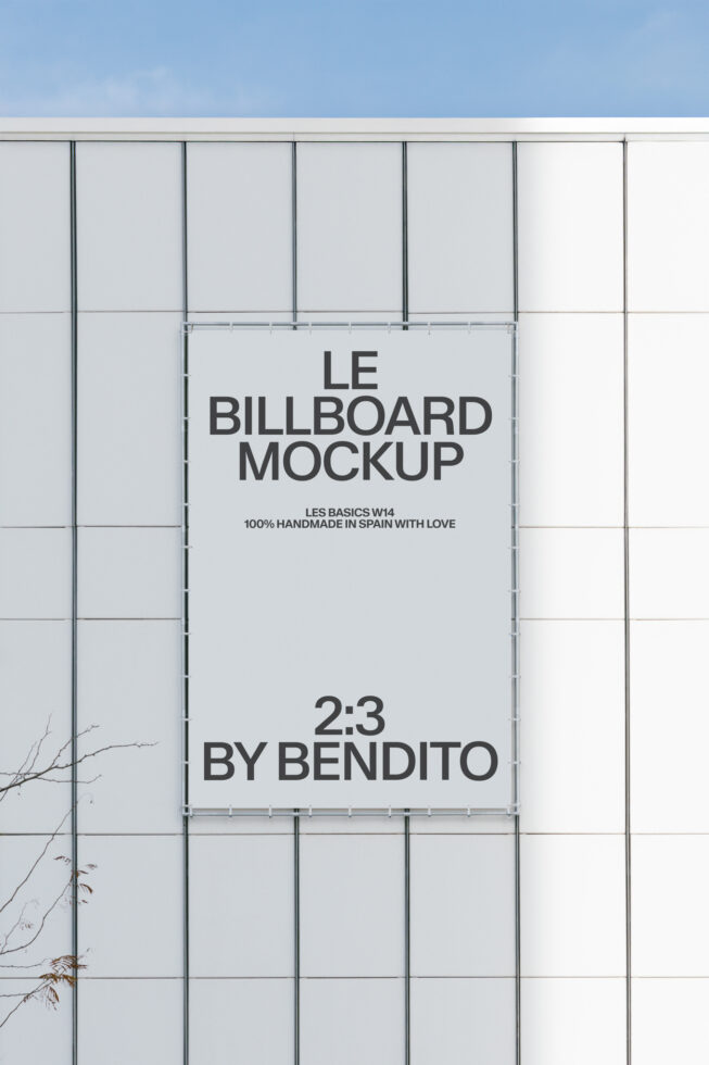 White 2:3 billboard mounted on industrial metal grid wall outdoor