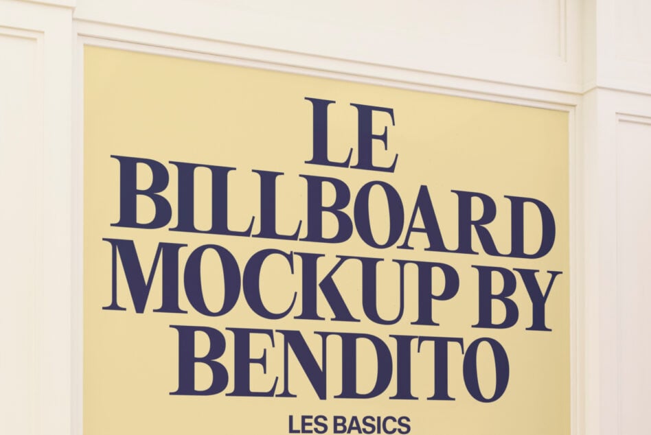 Pale yellow framed poster with dark blue serif lettering for Le Billboard Mockup