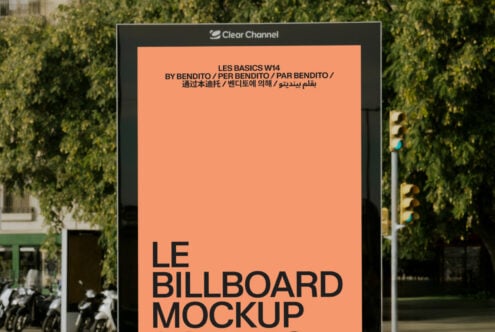 Outdoor billboard mockup with black frame displaying peach colored design space