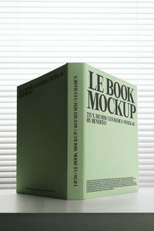 Sage green book cover mockup with dark spine text against textured wall surface