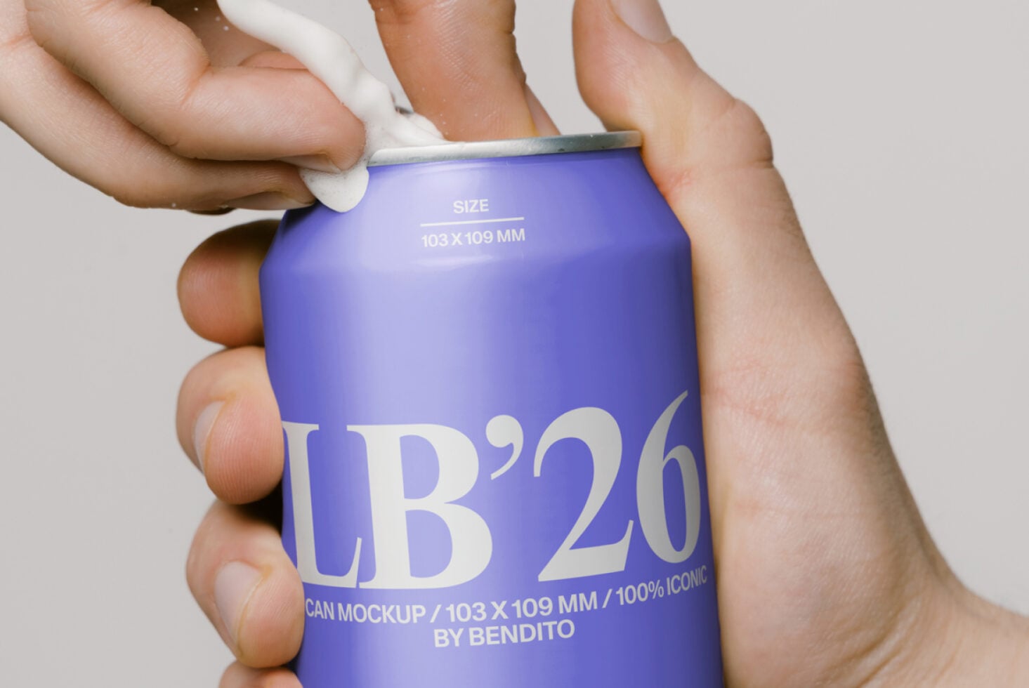Bright blue soda can labeled LB'26 being opened by hands against white background