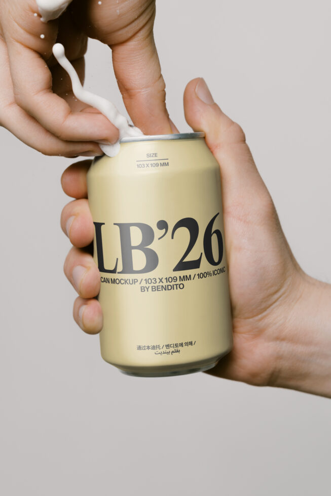 Cream colored beverage can with LB'26 branding held in hands with pull tab visible
