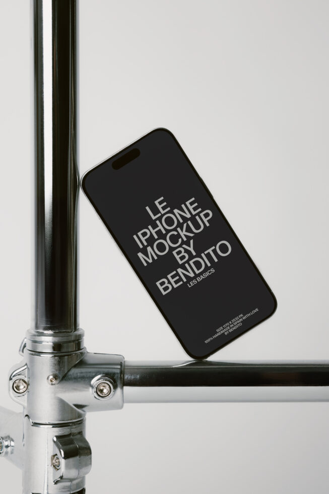 iPhone leaning against metal bike frame displaying text on black screen