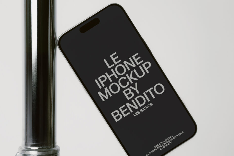 iPhone with black screen display leaning on metal tube against white backdrop