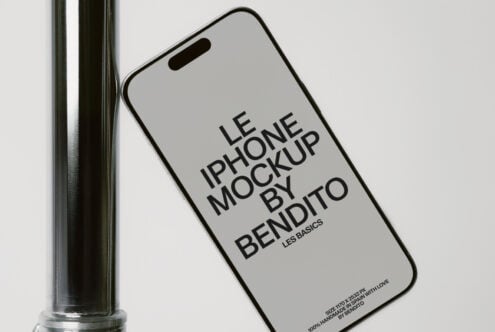 iPhone on metal pipe with light gray screen mockup in minimalist setup