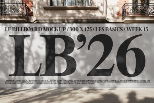 Black large format billboard on brick storefront with outdoor lighting