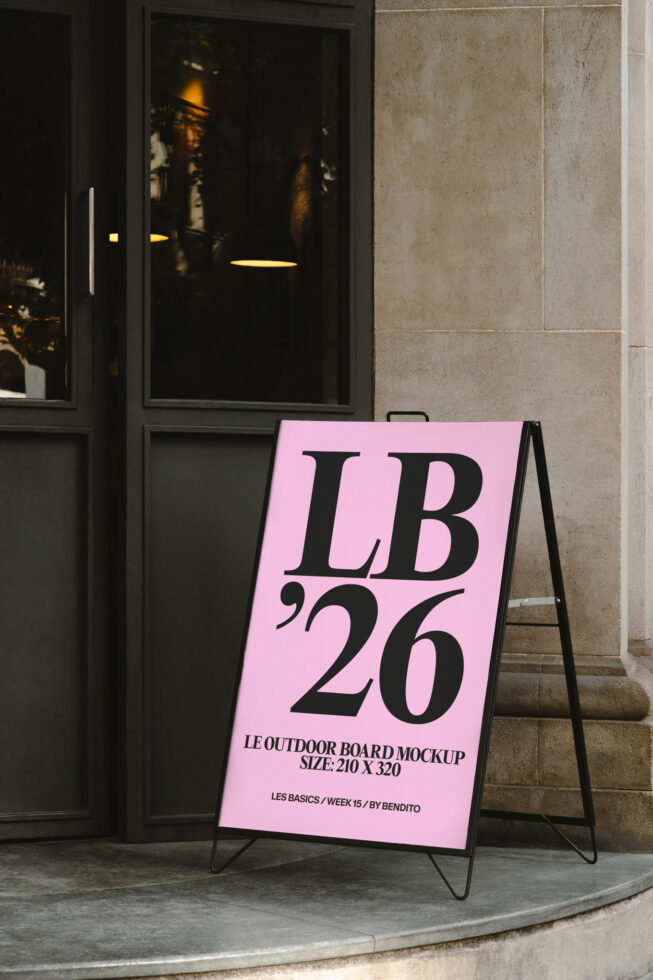 Bright pink A-frame sidewalk sign with LB 26 on storefront street corner
