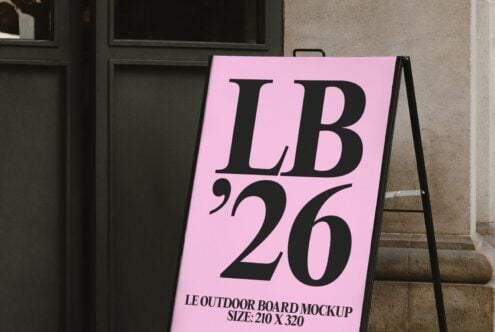 Oversized pink A-frame sign displaying LB 26 outside modern glass storefront