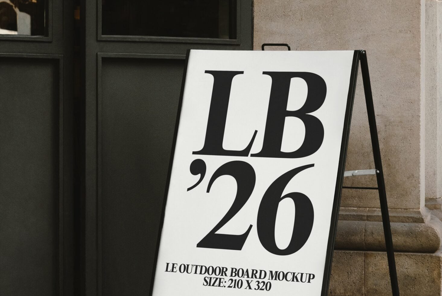 Outdoor A-frame sign with large serif letters reading LB26 on a street