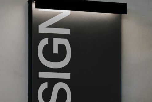 Wide white neon sign mockup with Le Siglo text glowing against dark interior space