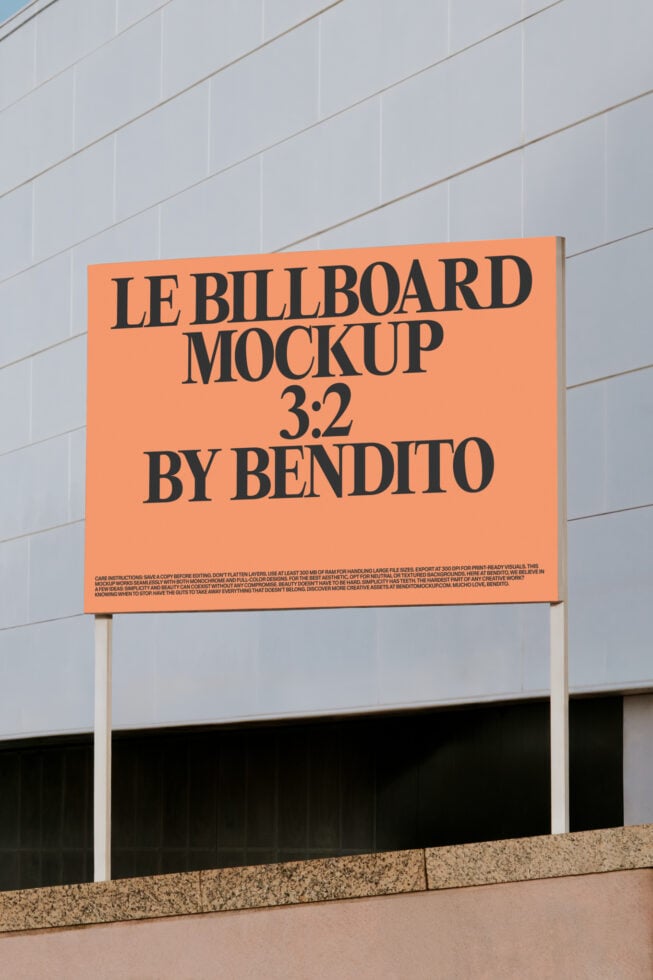 Bright orange billboard with black serif type mounted on white building facade