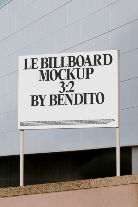 Cream billboard with black serif type mounted on white building facade