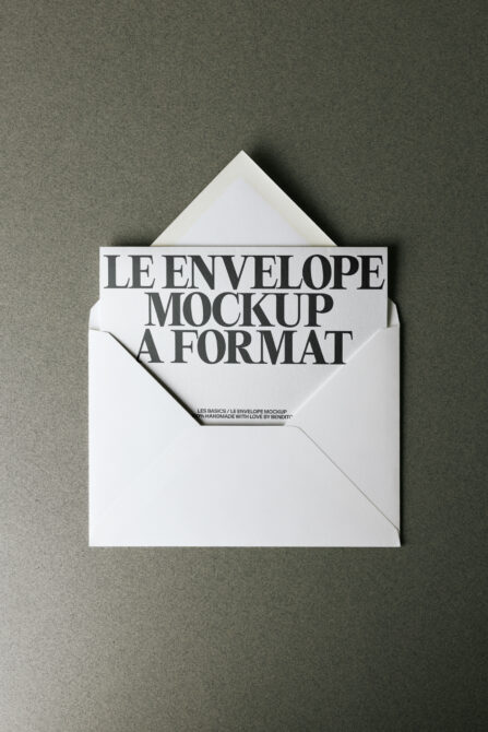 White envelope mockup open on green surface showing card inside