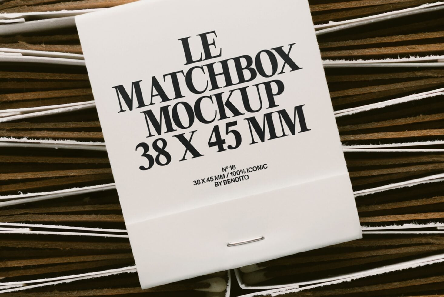 White matchbox on striped wood with black serif type layout