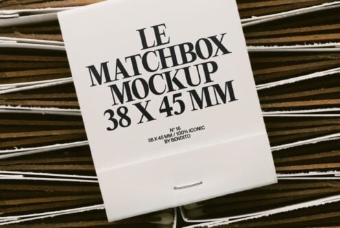 White matchbox on striped wood with black serif type layout