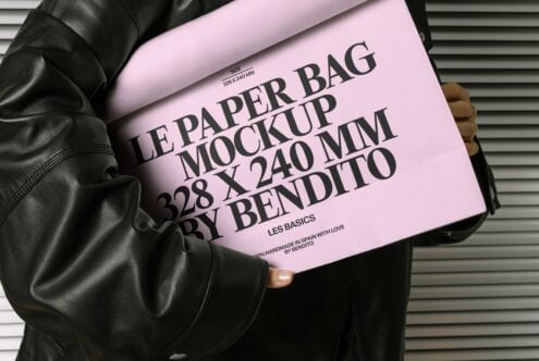 Pink paper bag mockup with black text layout on leather jacket background