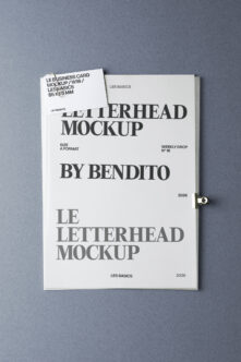 Letterhead mockup with business card on blue-gray backdrop showing serif typography
