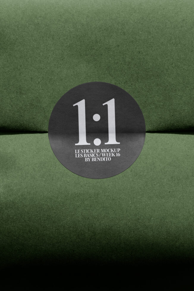 Round black sticker on green paper with version number printed