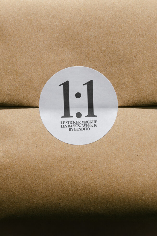 White circular sticker on kraft paper with bold typography display