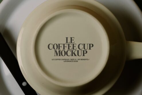 Flat lay of cream cup in saucer showing Le Coffee Cup Mockup text
