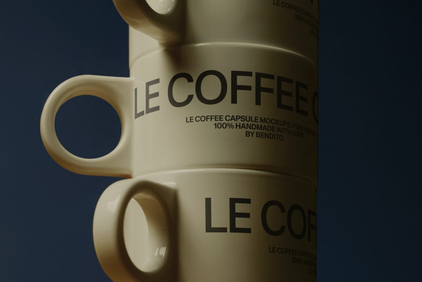 Close up of cream mug with Le Coffee Capsule Mockup text on dark blue