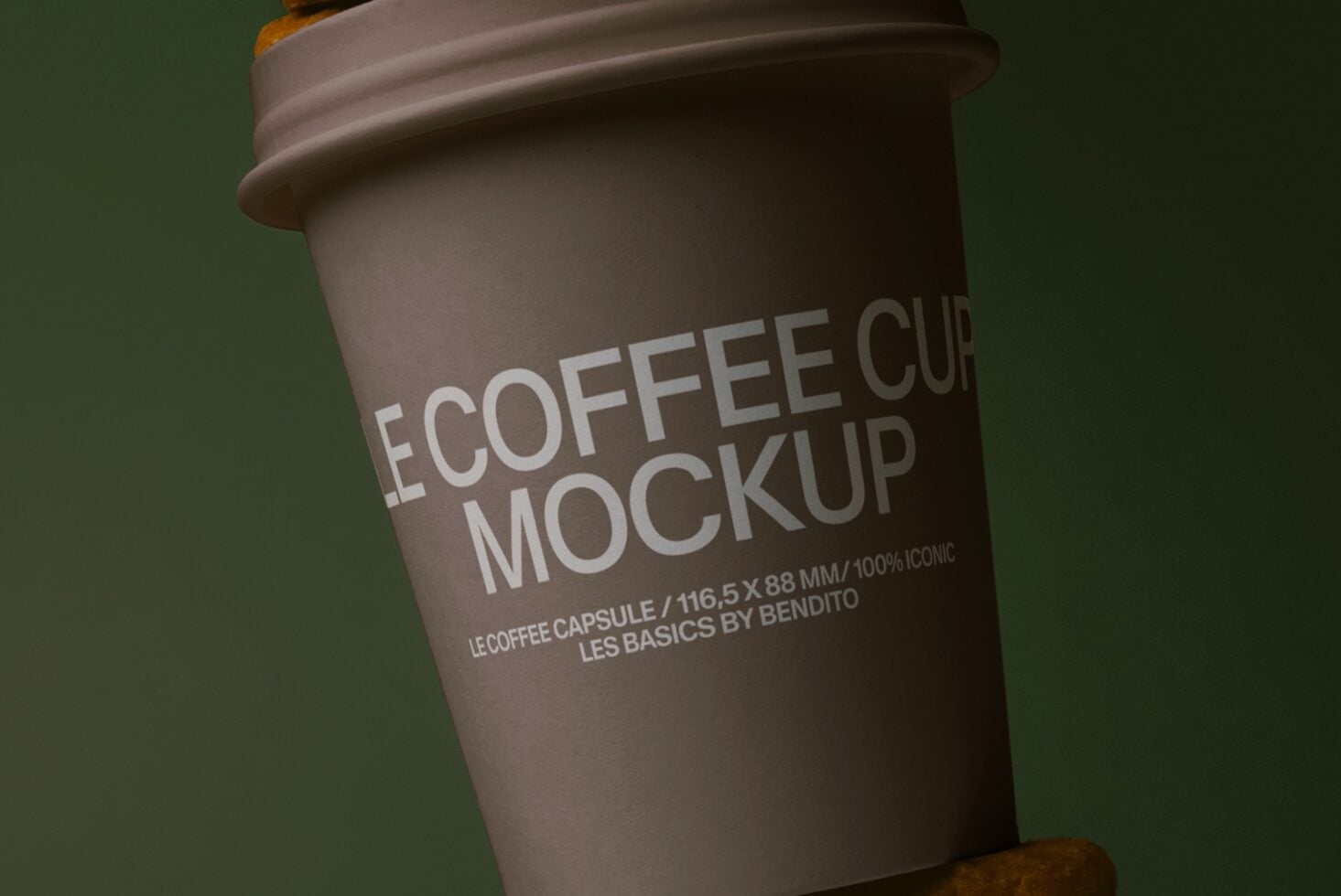 Dark brown cup with white label text, waffle cookies peeking above on green