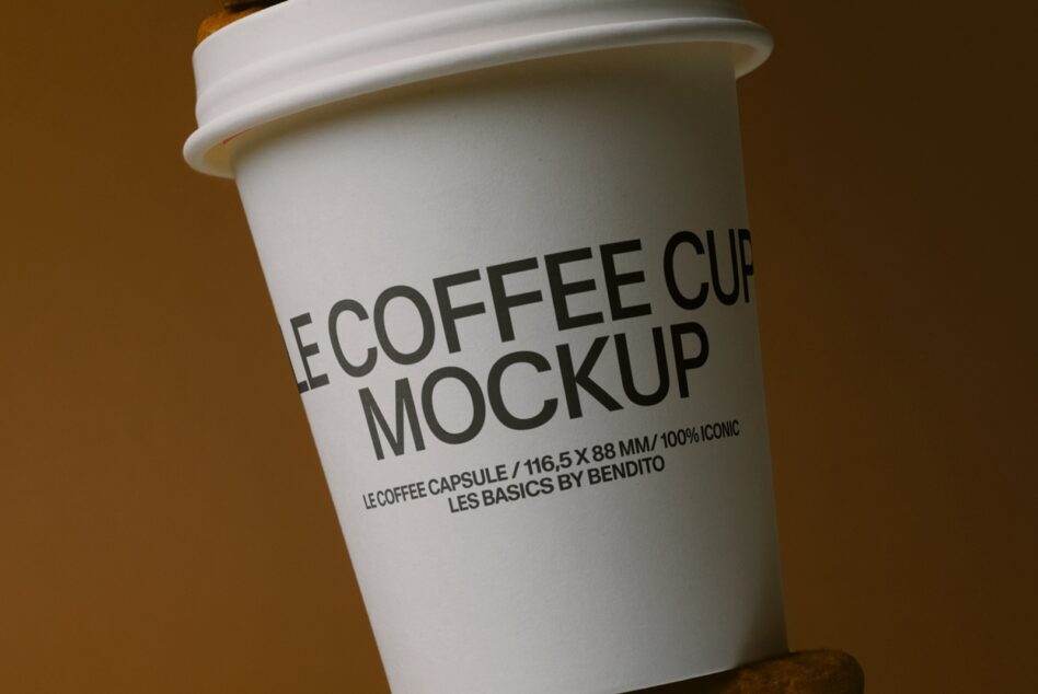 White cup with dark text label, waffle cookie base visible on warm background