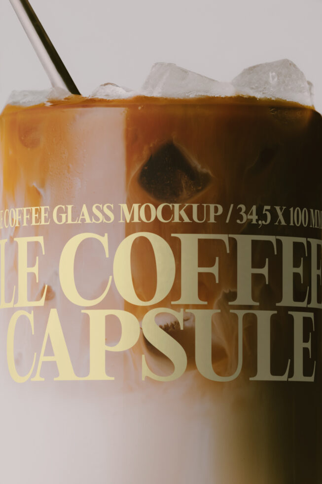Iced coffee glass mockup with gold text overlay on white background, ice cubes visible