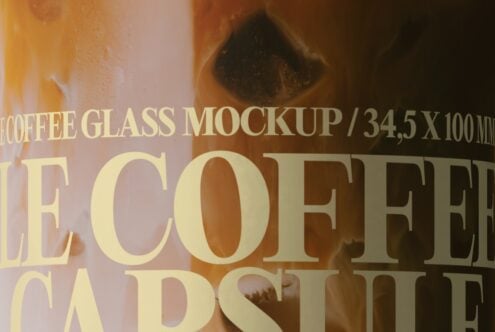 Iced coffee glass mockup with gold serif lettering overlay on neutral background
