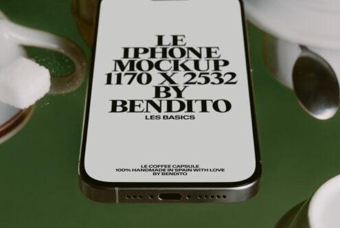 iPhone mockup on green background showing white screen with black text, ceramic cups