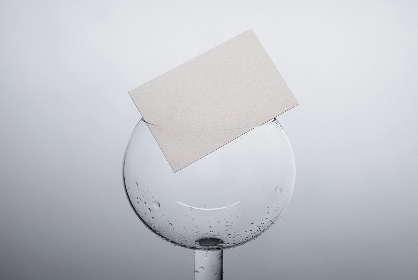 Clean business card template displayed on dewy glass sphere product shot