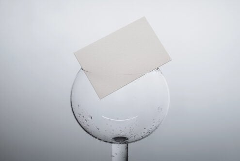 Clean business card template displayed on dewy glass sphere product shot