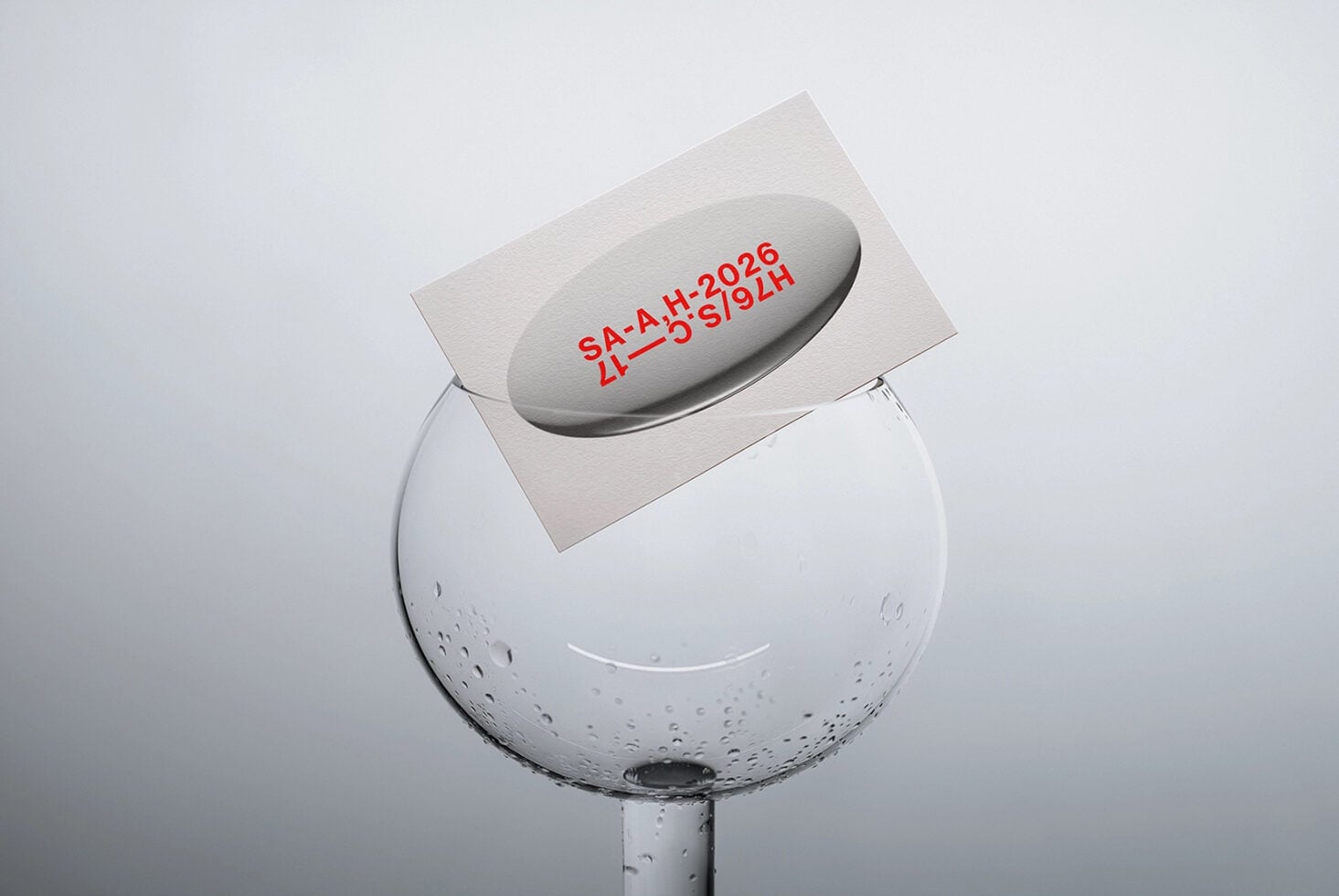 Red text stamped on curved glass sphere mockup floating above water