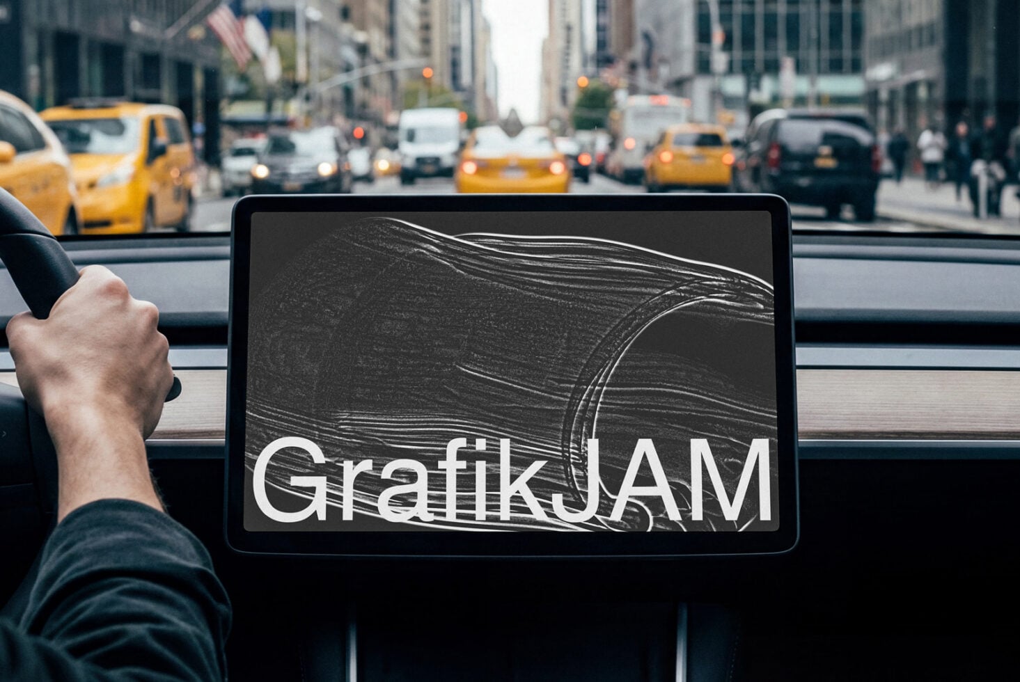 Tablet showing scratched metal texture with GrafikJAM logo on car dashboard overlooking NYC yellow cabs