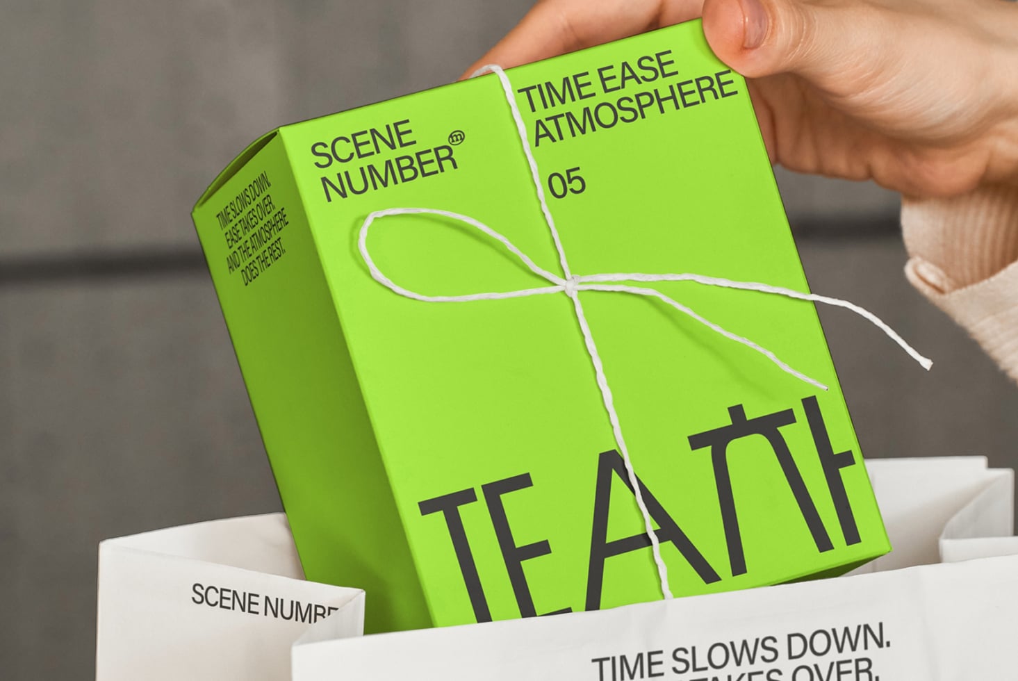 Bright green box with white twine bow, Scene Number branding on side