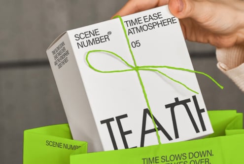 White greeting card with green twine bow, Scene Number branding visible