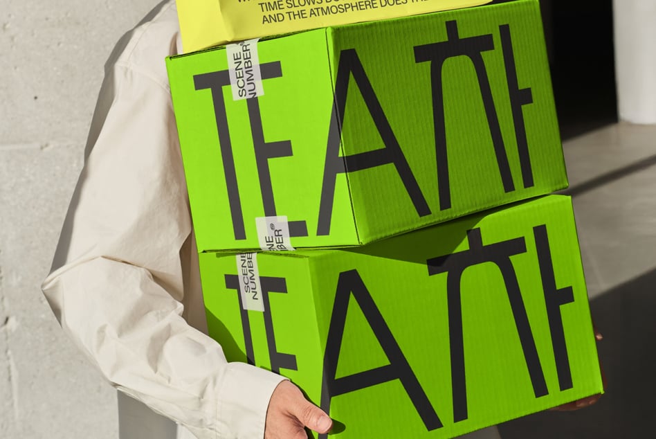 Stacked lime green book covers with bold black TEAITT text, held in hands