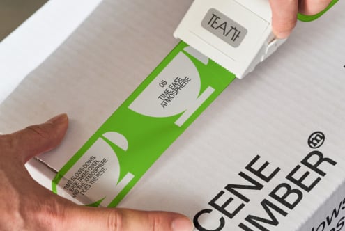 White tape dispenser with TEATT branding being pulled from lime green box