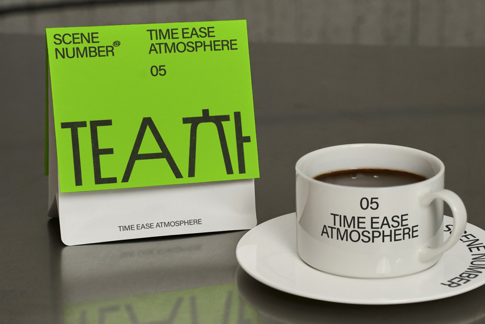 Tilted green paper sleeve with TEAM text alongside white ceramic mug with coffee