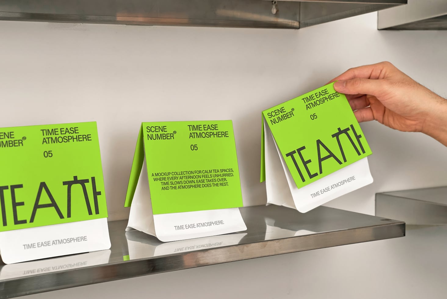 Bright lime green tea box mockups with white panels displayed on metal shelf