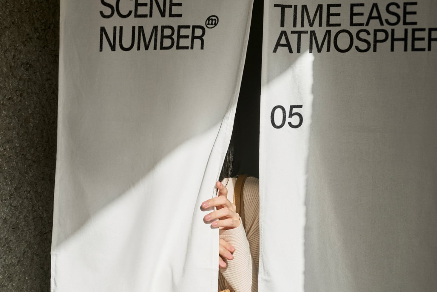 Beige clapper board with text and number 05 held between two people