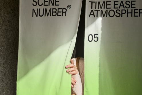 Close up of white clapper board text between two people's hands outdoors