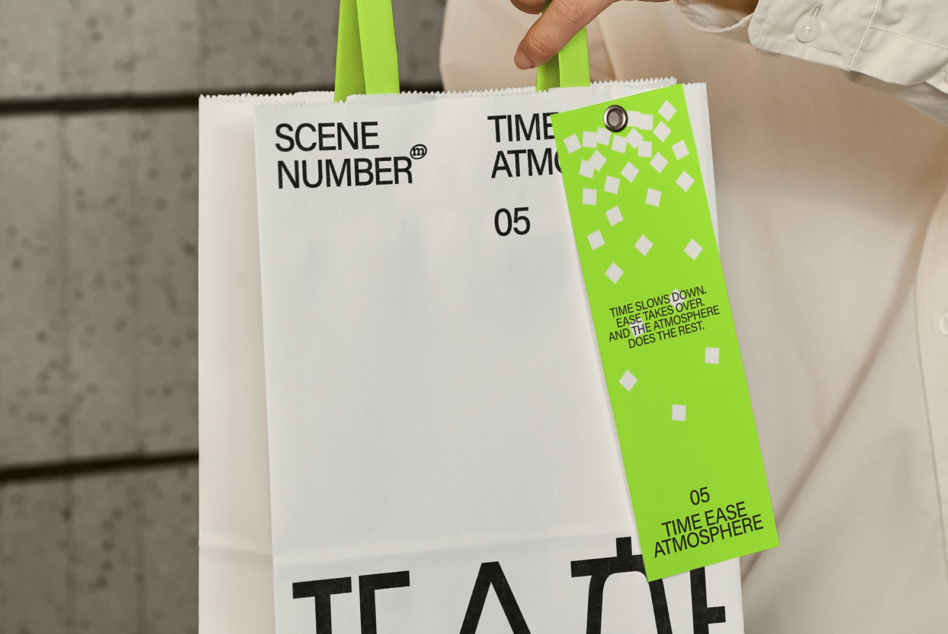 Hand holding white clapper board with lime green side panel mockup