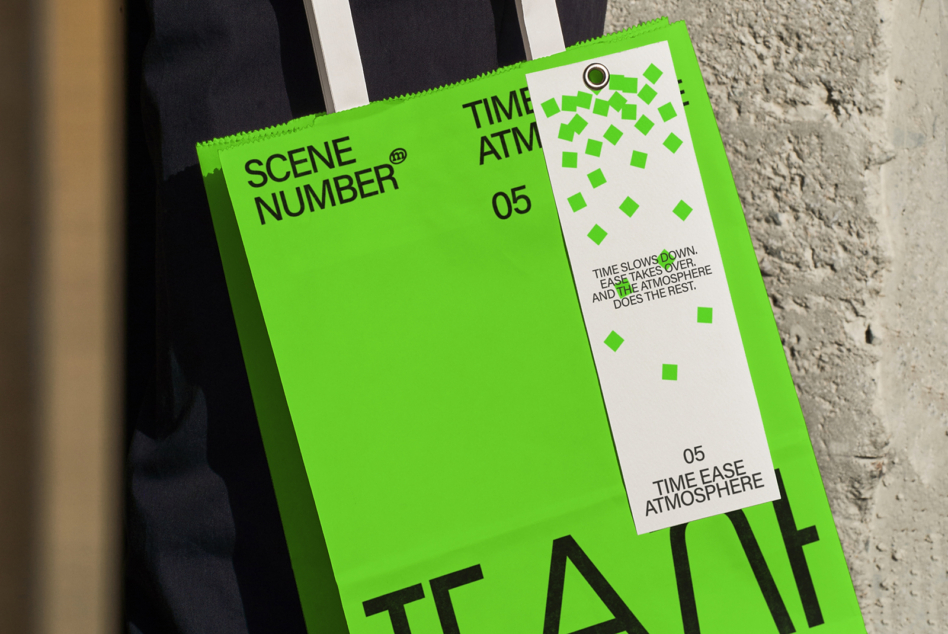 Neon green clapper board with white text labels, propped on concrete ground