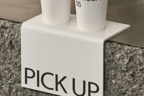 White display block with two white cylinders holding PICK UP label mockup