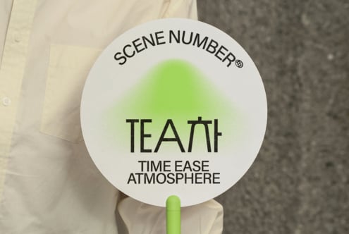 Round white scene clapper with lime gradient circle in center