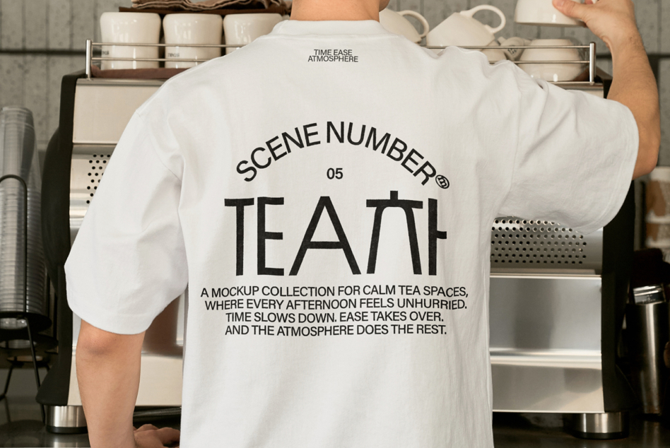 Person wearing white tee with Scene Number 05 Tea mockup in kitchen setting