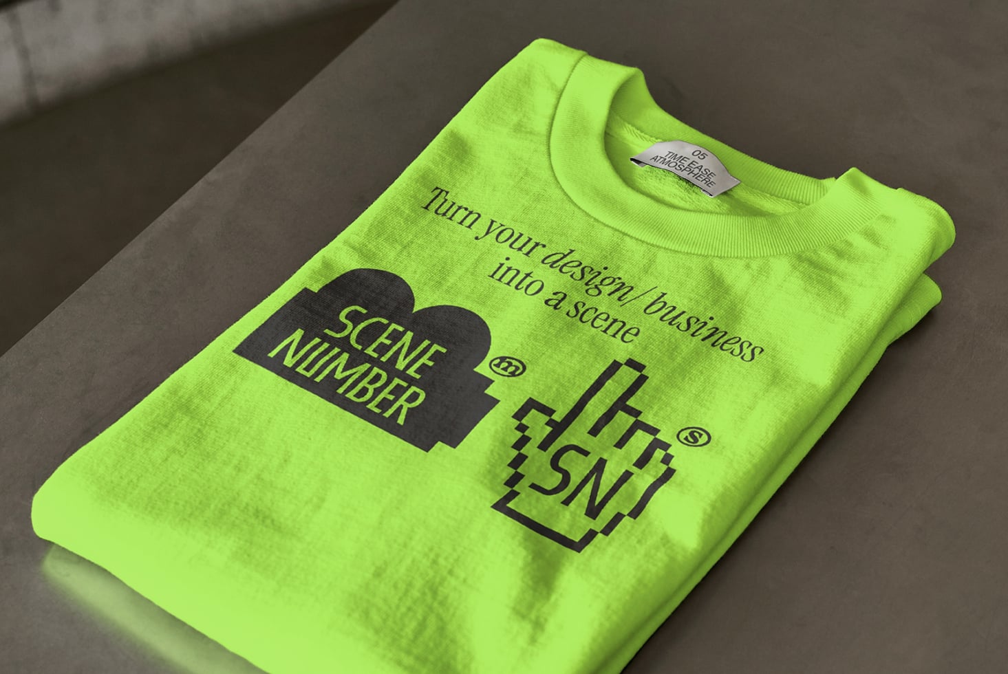 Neon lime sweatshirt with Scene Number branding flatlay on neutral background