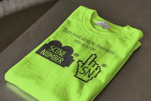 Neon lime sweatshirt with Scene Number branding flatlay on neutral background
